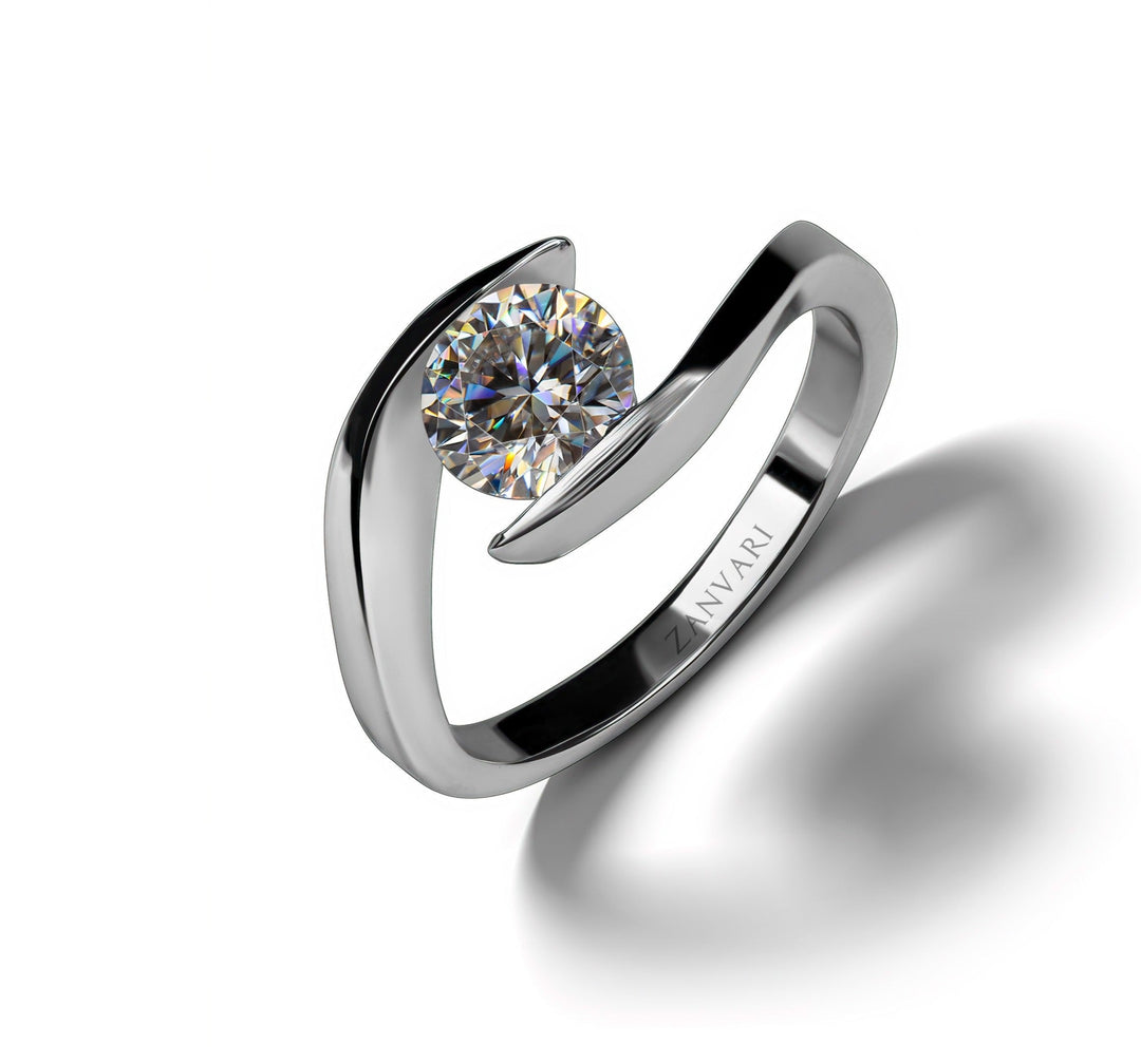  A modern silver ring featuring a large round Moissanite stone in a unique tension setting, with the brand name "ZANVARI" inscribed on the band.