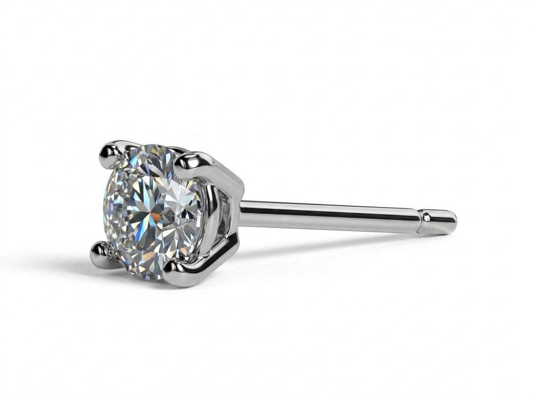 Close-up of male ear wearing a four-prong round diamond stud earring.