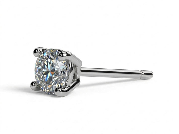 Close-up of male ear wearing a four-prong round diamond stud earring.