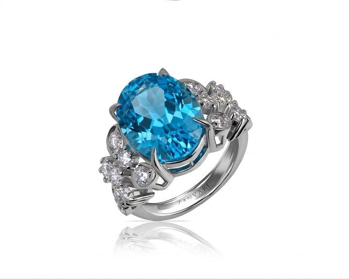 Luxury oval-cut Swiss blue topaz statement ring with round diamond accents on white gold band.