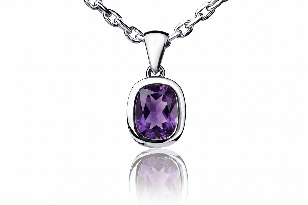 A silver pendant necklace featuring a cushion-cut purple amethyst gemstone in a bezel setting, suspended from a silver link chain against a white background with a soft reflection below.
