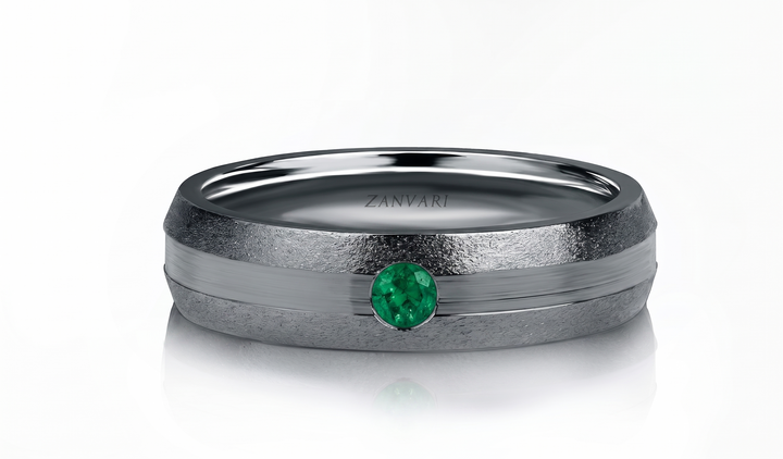 A ZANVARI ring featuring a textured matte gray band with a polished silver center channel and a round-cut green emerald gemstone, shown on a clean white background.