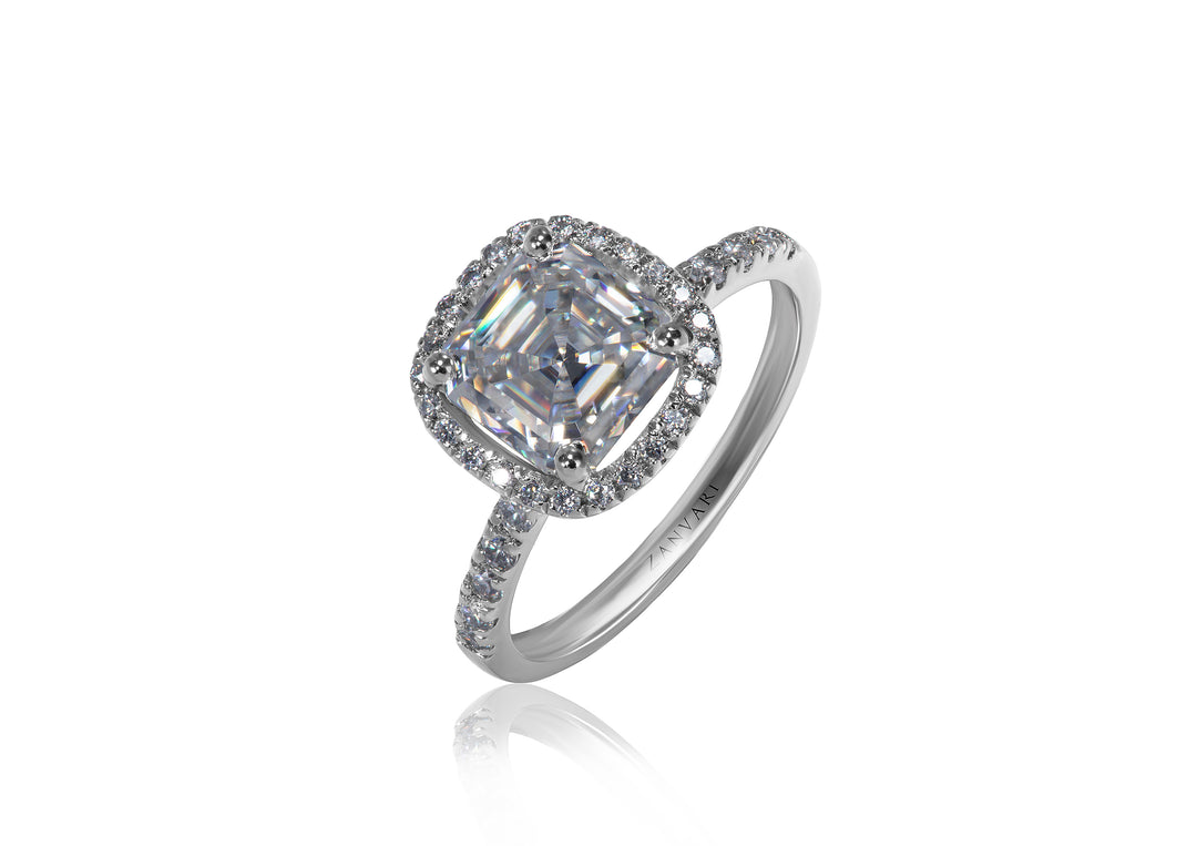 Silver ring with a 2 carat moissanite asscher cut and smaller moissanites around on a white background