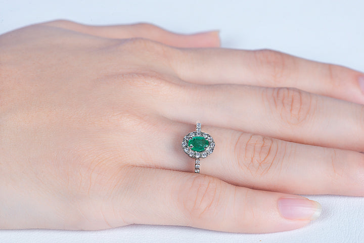 Model gracefully wearing emerald stone ring in silver 925