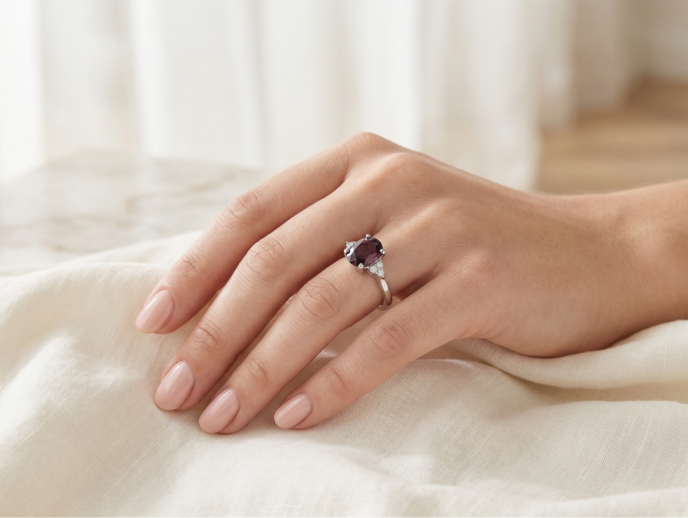 Garnet ring worn by a model in silver