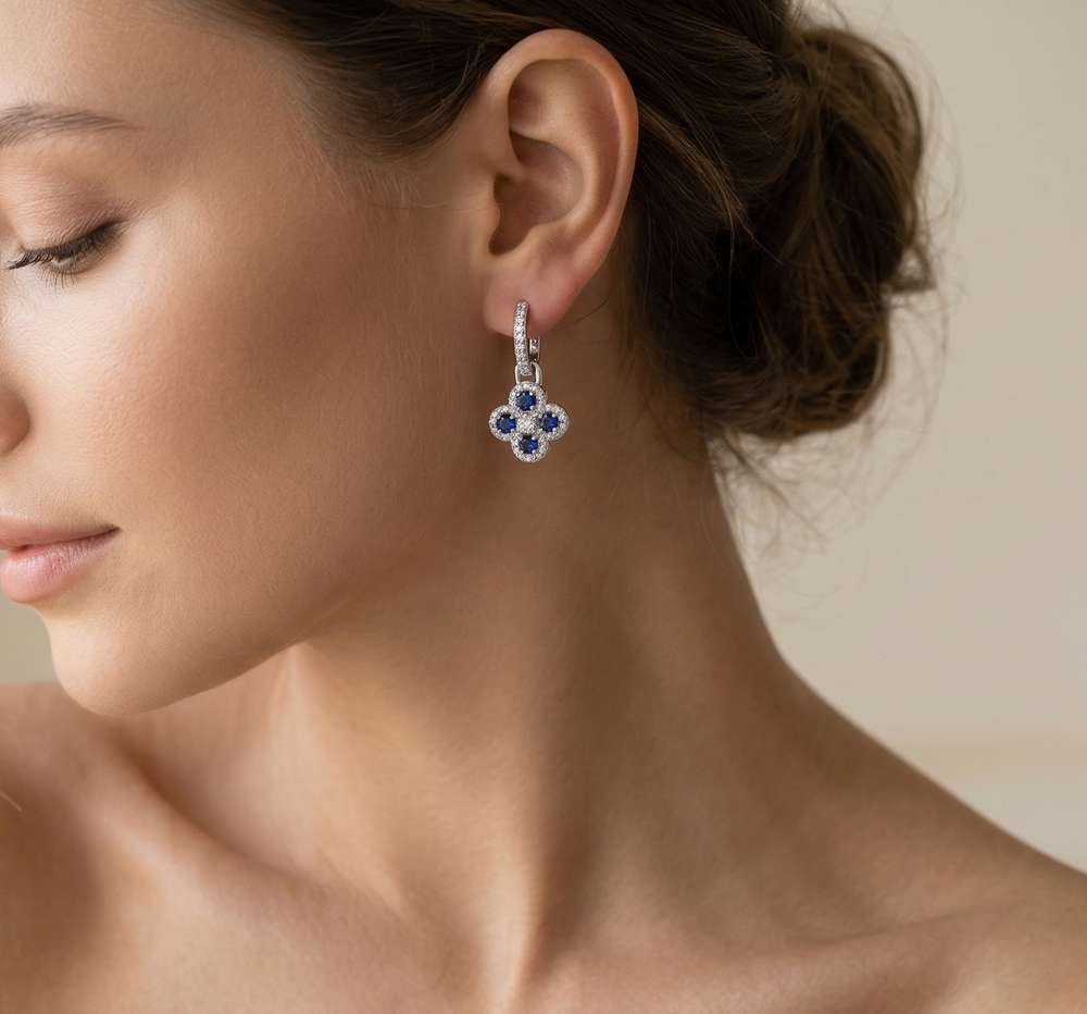 Woman wearing a pair of earrings with a neutral background