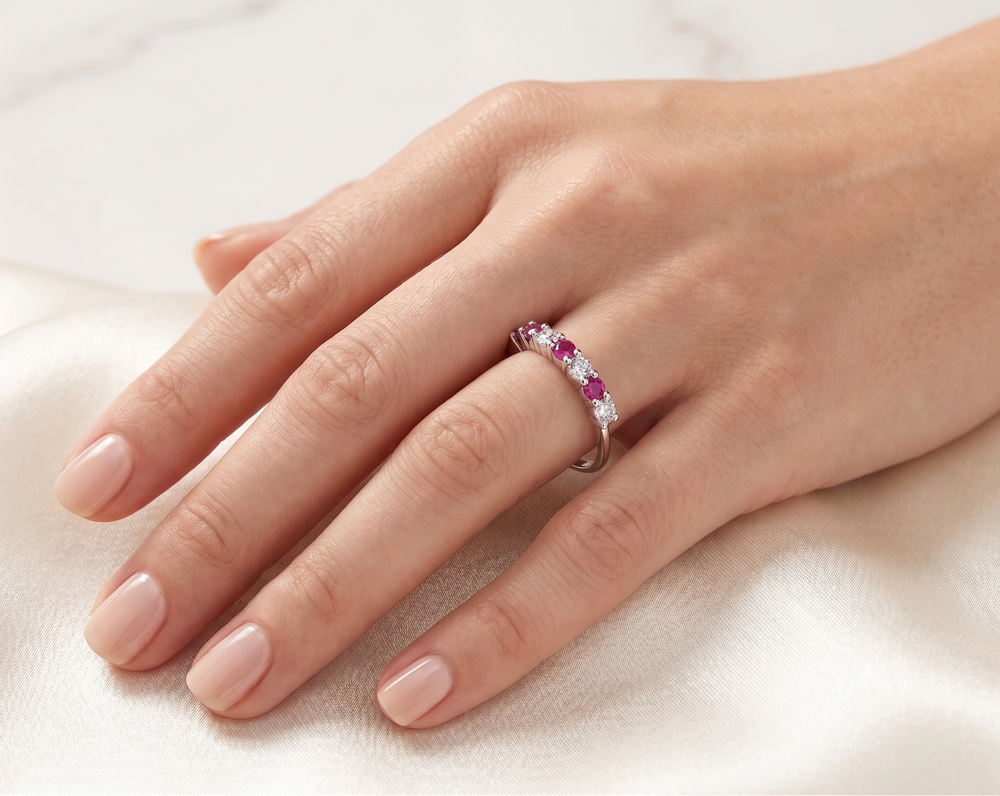 Hand wearing the Gleam of Ruby and Moissanite Ring by Zanvari Pakistan — alternating natural ruby and moissanite in 925 sterling silver band.