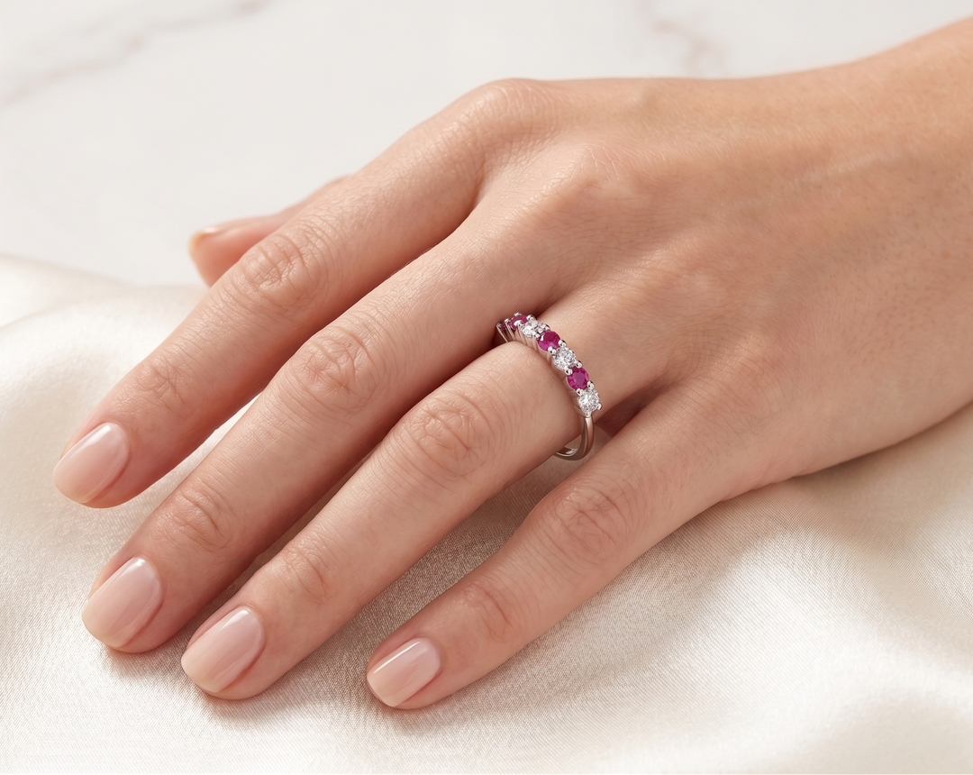 Hand wearing the Gleam of Ruby and Moissanite Ring by Zanvari Pakistan — alternating natural ruby and moissanite in 925 sterling silver band.