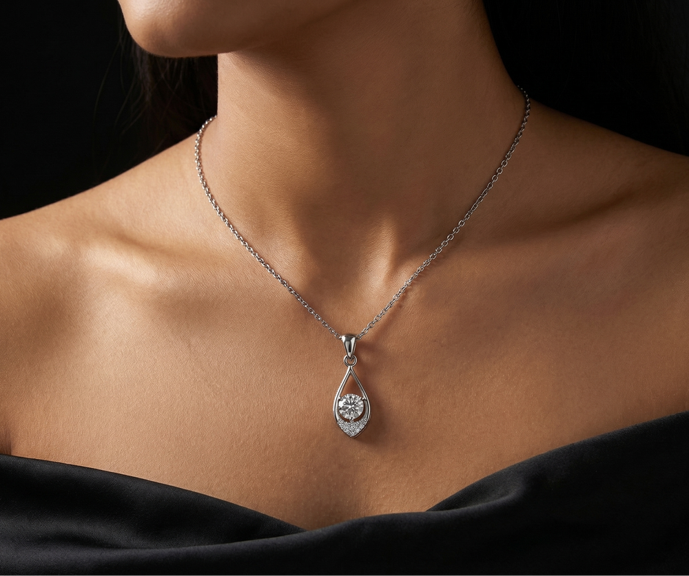 Necklace with a moissanite pendant worn by a girl against a black background