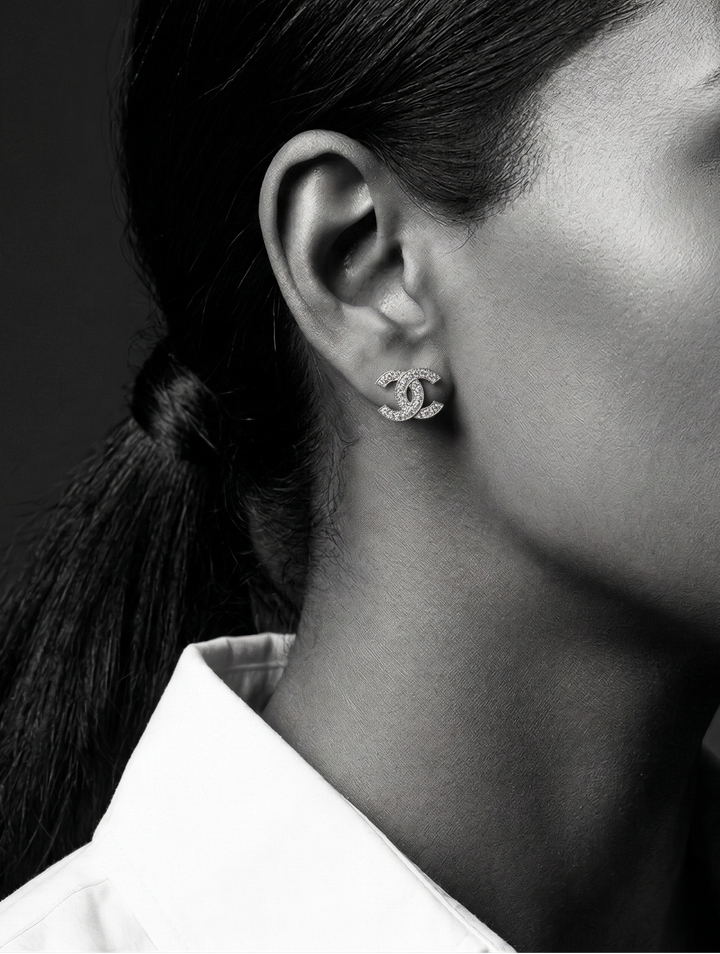 Black and white portrait of a woman wearing earrings with a blurred background