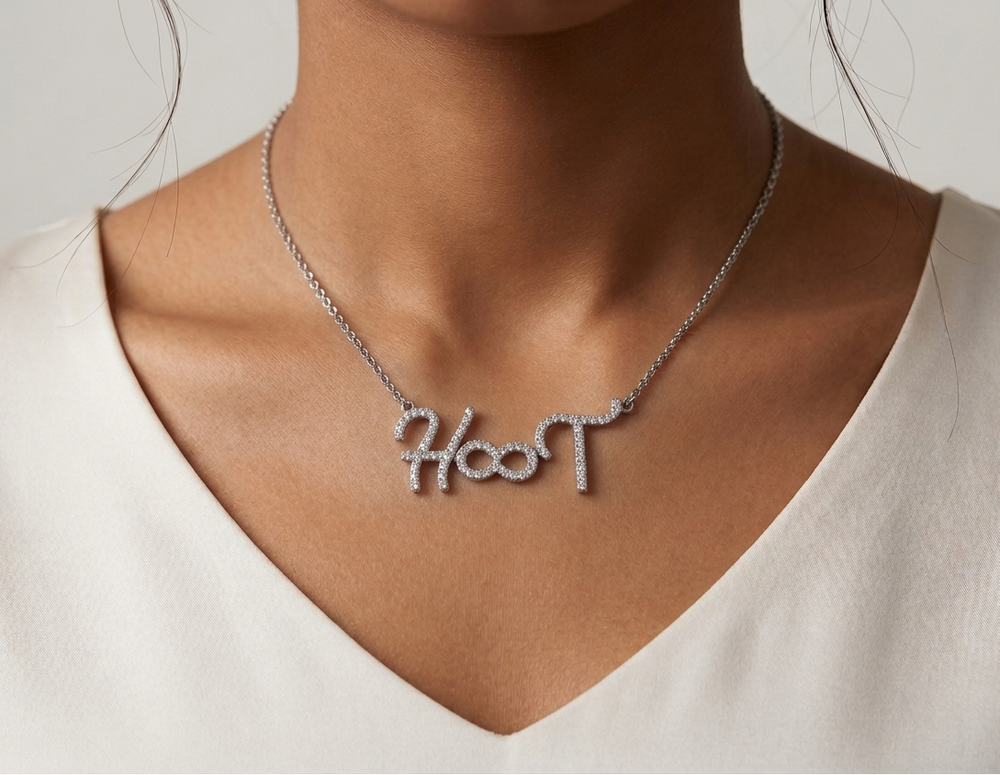 Necklace with 'name engraved personalised' pendant worn by a person against a neutral background