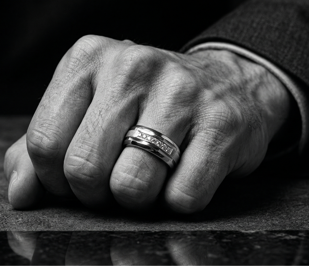 Close-up of a hand wearing a ring on a reflective surface