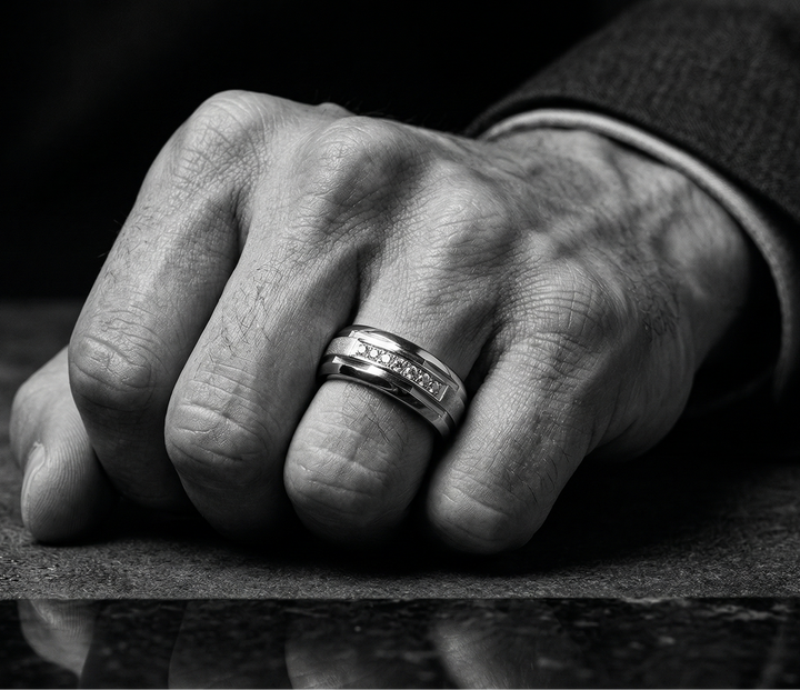 Close-up of a hand wearing a ring on a reflective surface