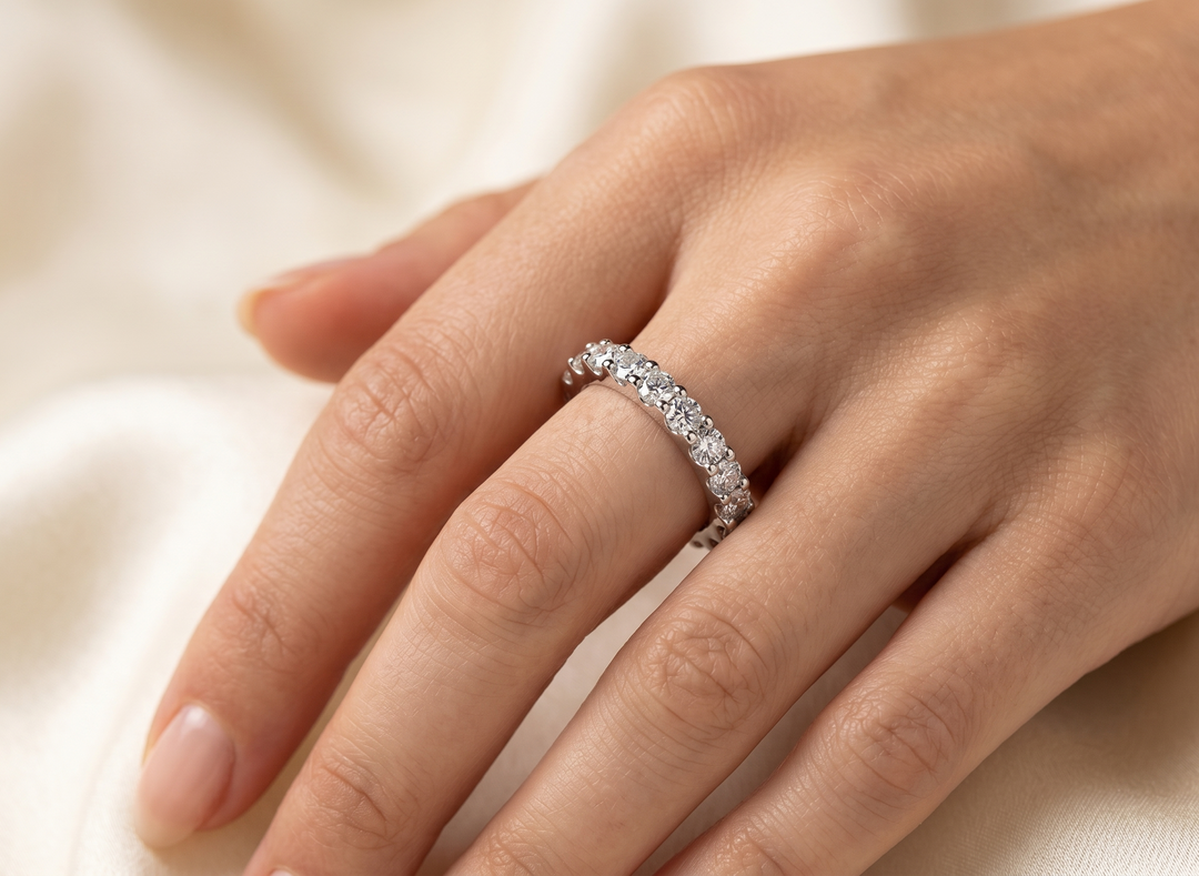 Close-up of L'Amour Eternity Band by Zanvari Pakistan showing 13 moissanite stones set in a continuous row across the 925 sterling silver band.