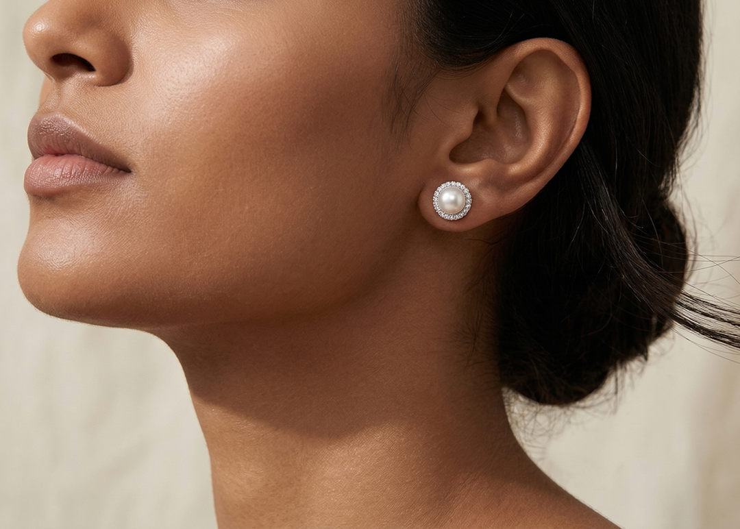 Model wearing Ocean's Grace Pearl Studs by Zanvari Pakistan — natural 8mm moti pearl earrings in 925 sterling silver on the ear.