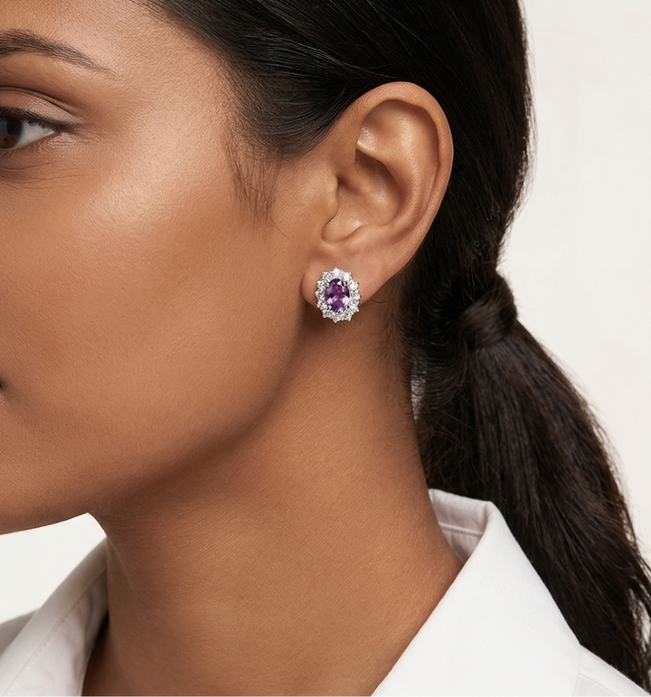 Woman wearing a amethyst  gemstone earring on a white background