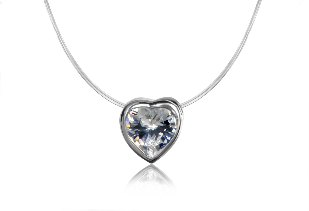 Heart-shaped crystal pendant on a white chain against a white background