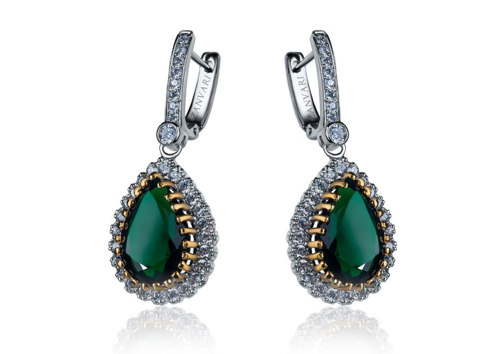 A pair of silver sterling earrings with white gold plating, featuring lab-created green emerald stones surrounded by cubic zirconia.