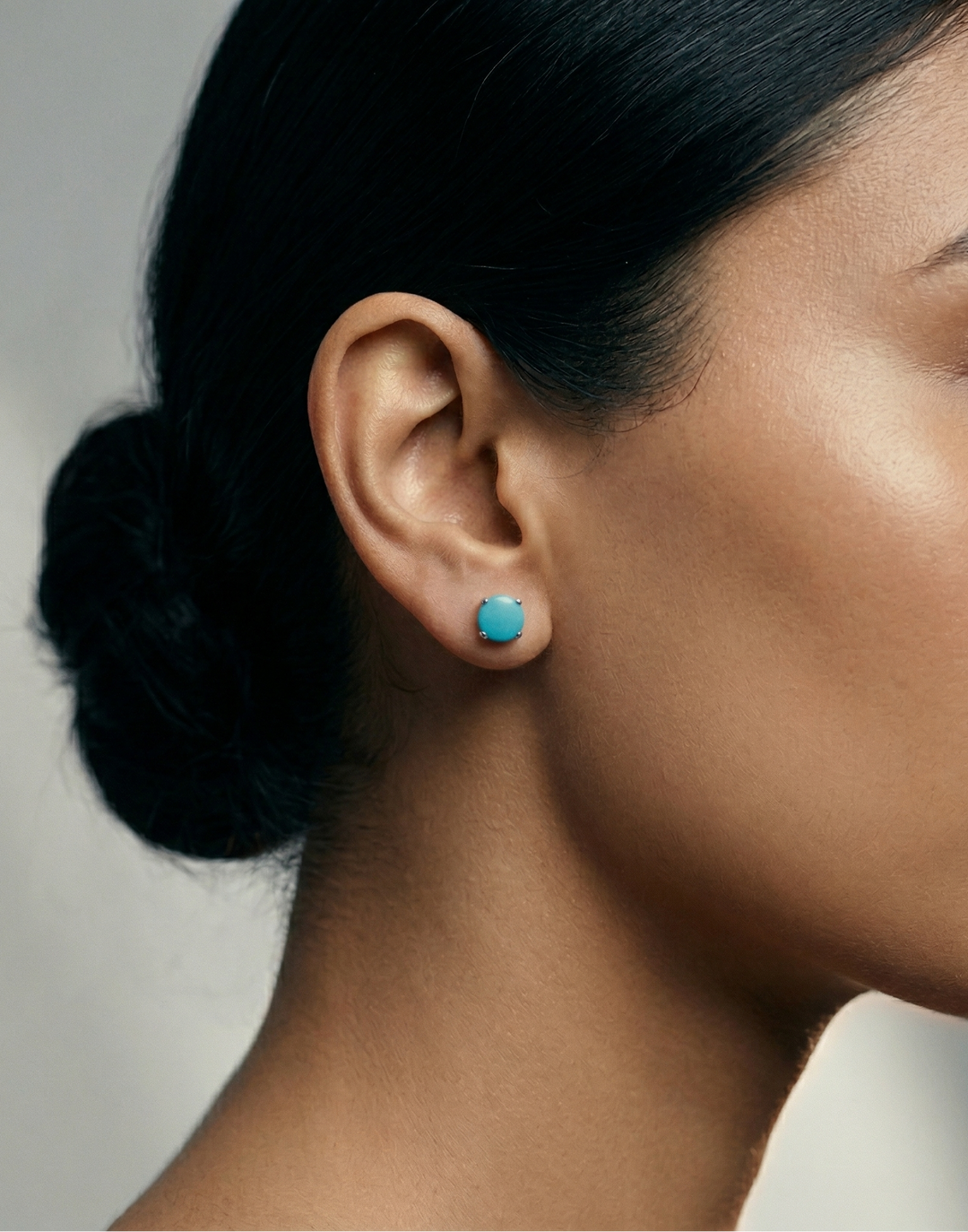 Model wearing turquoise studs in silver