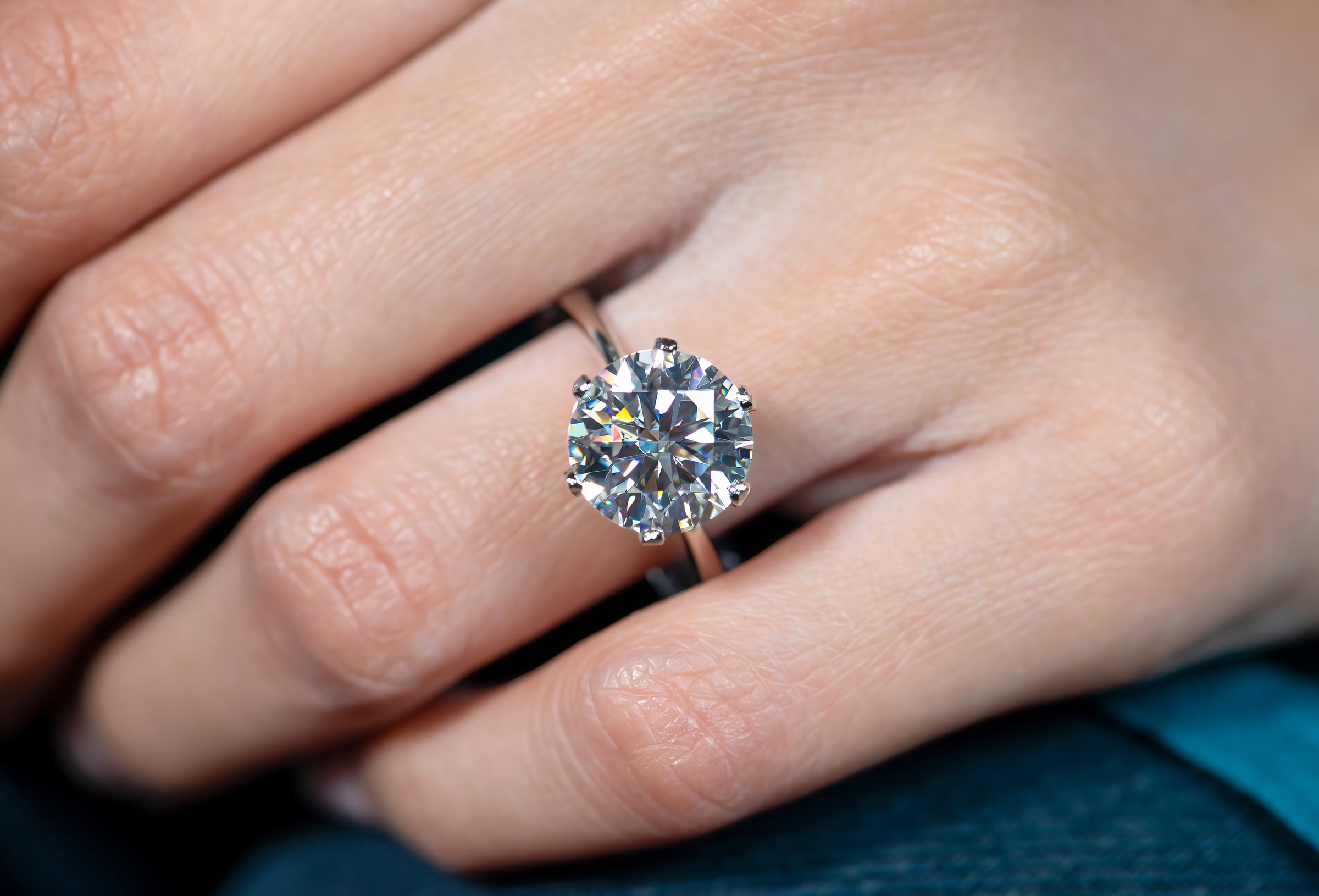 A model wearing 5 carat moissanite ring made in 925 sterling silver 