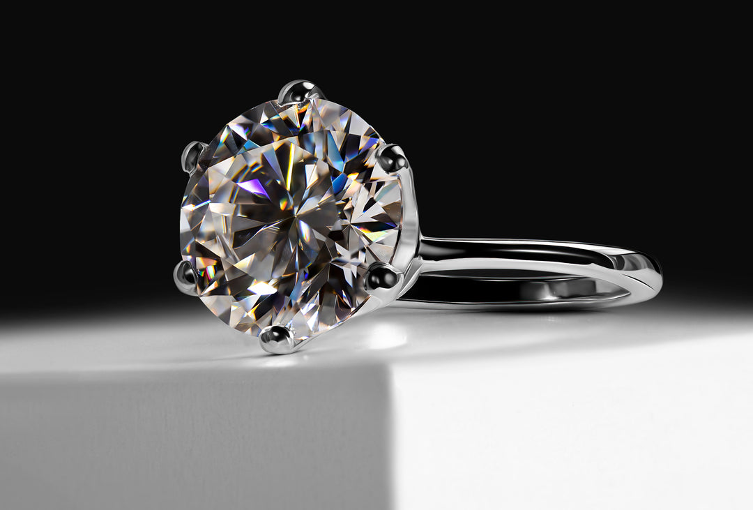 A 5-carat Moissanite ring, which serves as an alternative to a diamond, crafted in a 925 sterling silver band on a white box with black background 