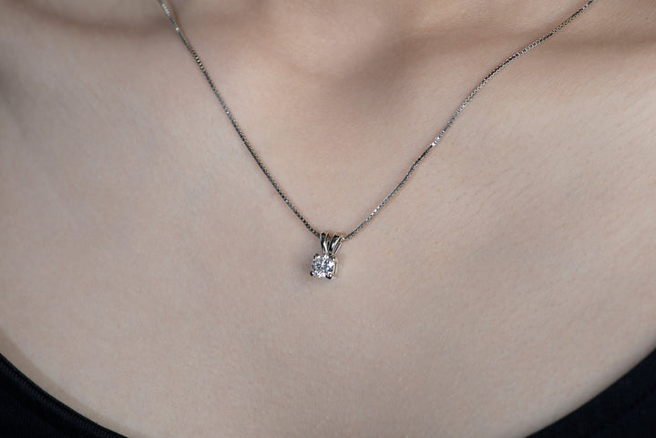 A model with a black top wearing delicate moissanite pendant with Italian boxed chain made in 925 silver