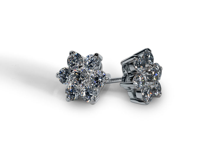 A pair of white gold-plated silver floral stud earrings with moissanite stones.