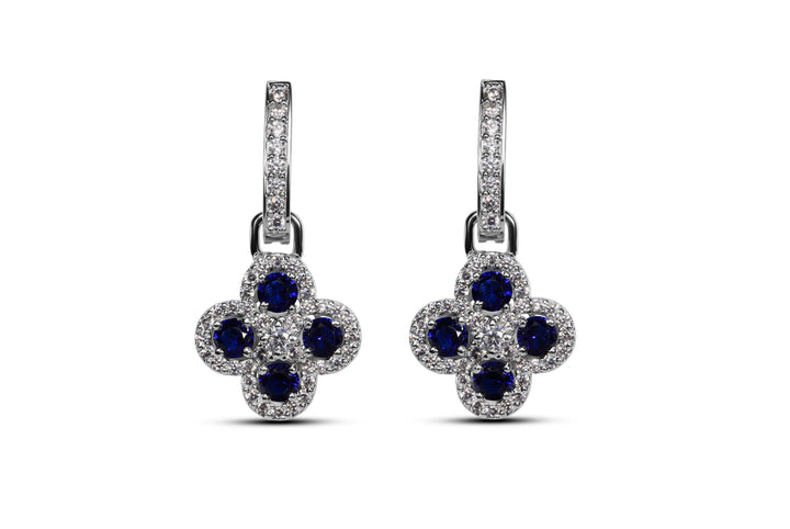 A pair of floral-inspired earrings with blue synthetic sapphires and zirconia accents set in 925 sterling silver.
