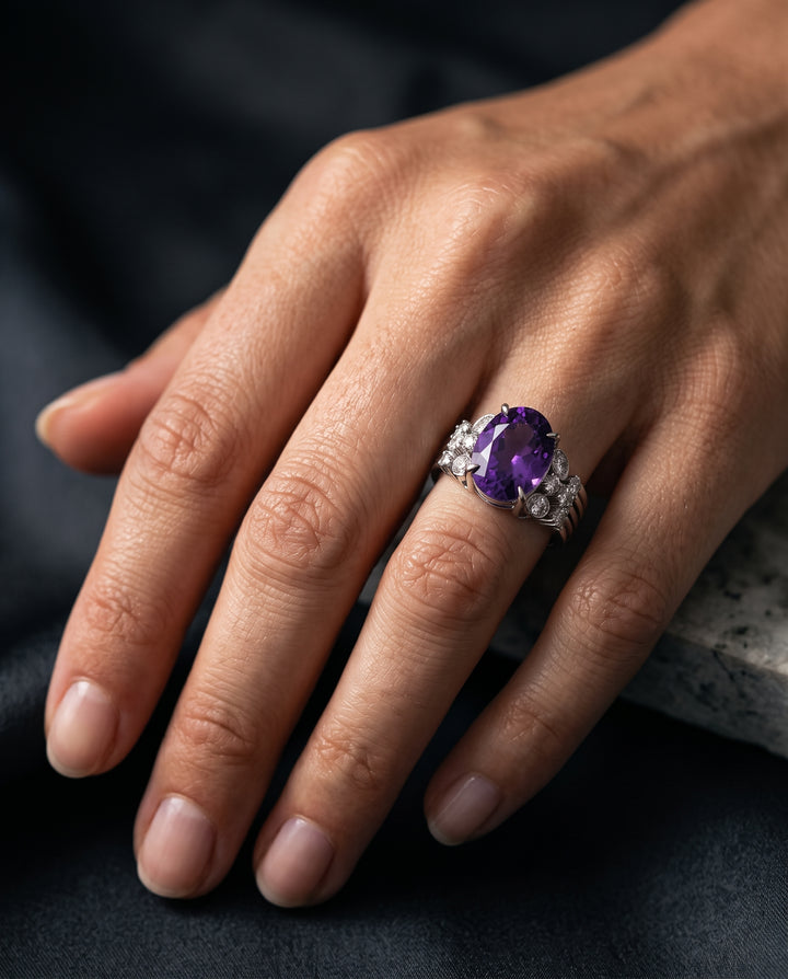 Model of Zanvari wearing 10 carat amethyst stone with accent moissanite stones ring in silver