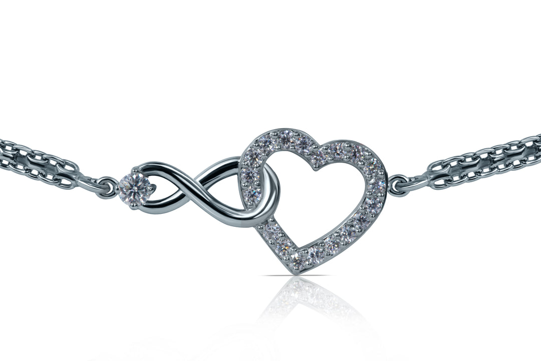 Silver anklet with heart and infinity symbol on a white background
