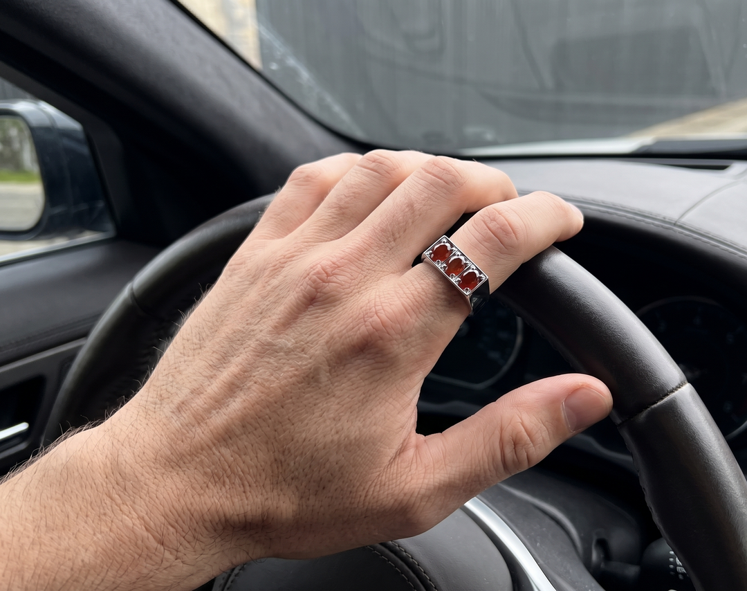 Men's 925 sterling silver ring set with three oval natural aqeeq in a row, prong-set in a raised rectangular head on a wide polished band.