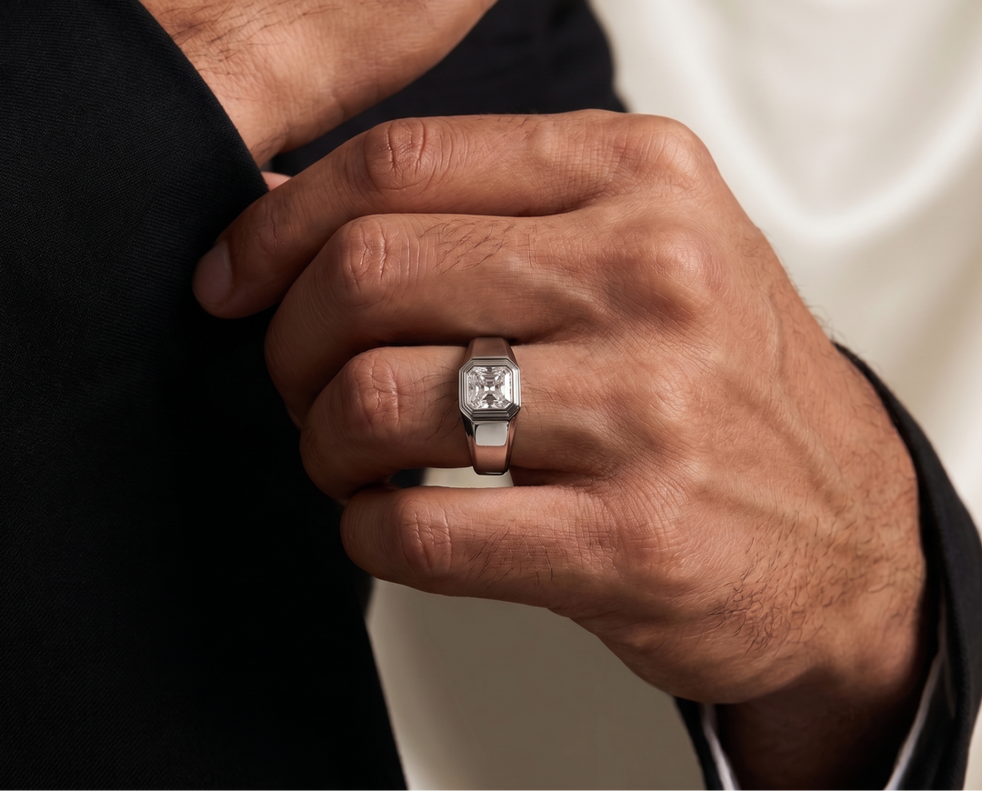 Hand wearing a moissanite wedding ring with a neutral background
