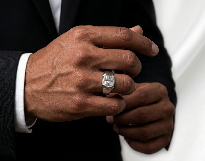 Close-up of a person's hands wearing an asscher cut moissanite silver ring, with a focus on the jewelry.