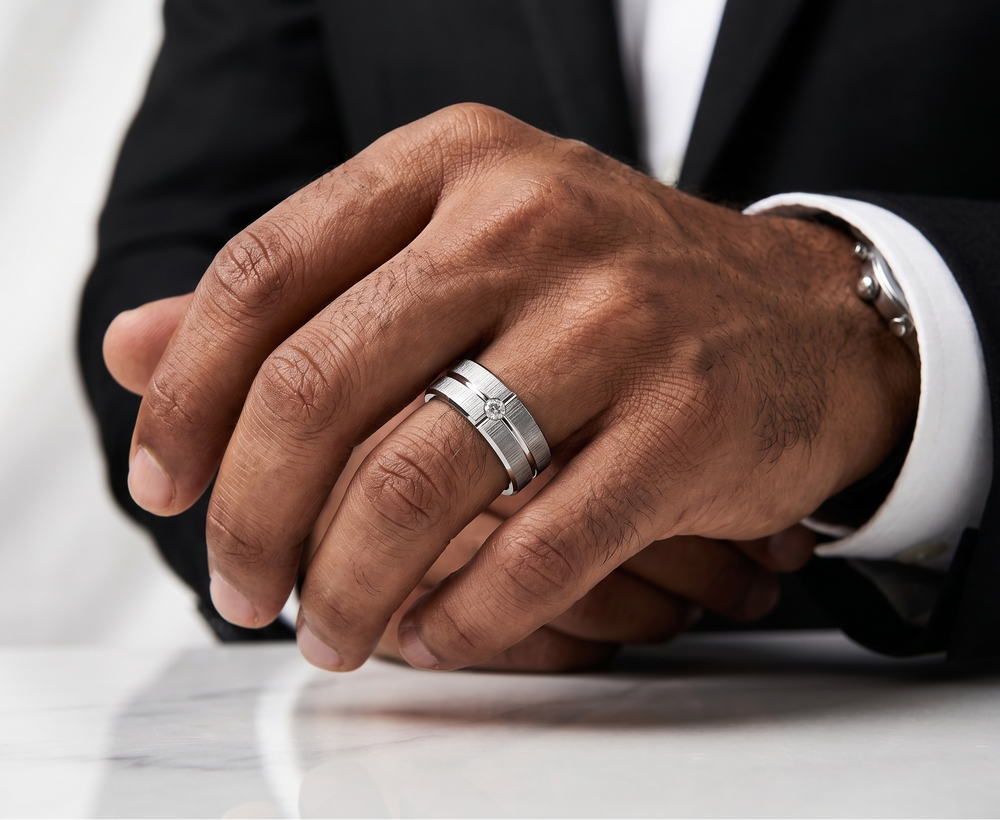 Close-up of a person's hands with a silver ring on a white background
