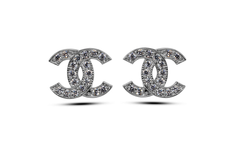 A pair of silver stud earrings featuring the iconic Chanel interlocking double C design with sparkling details.