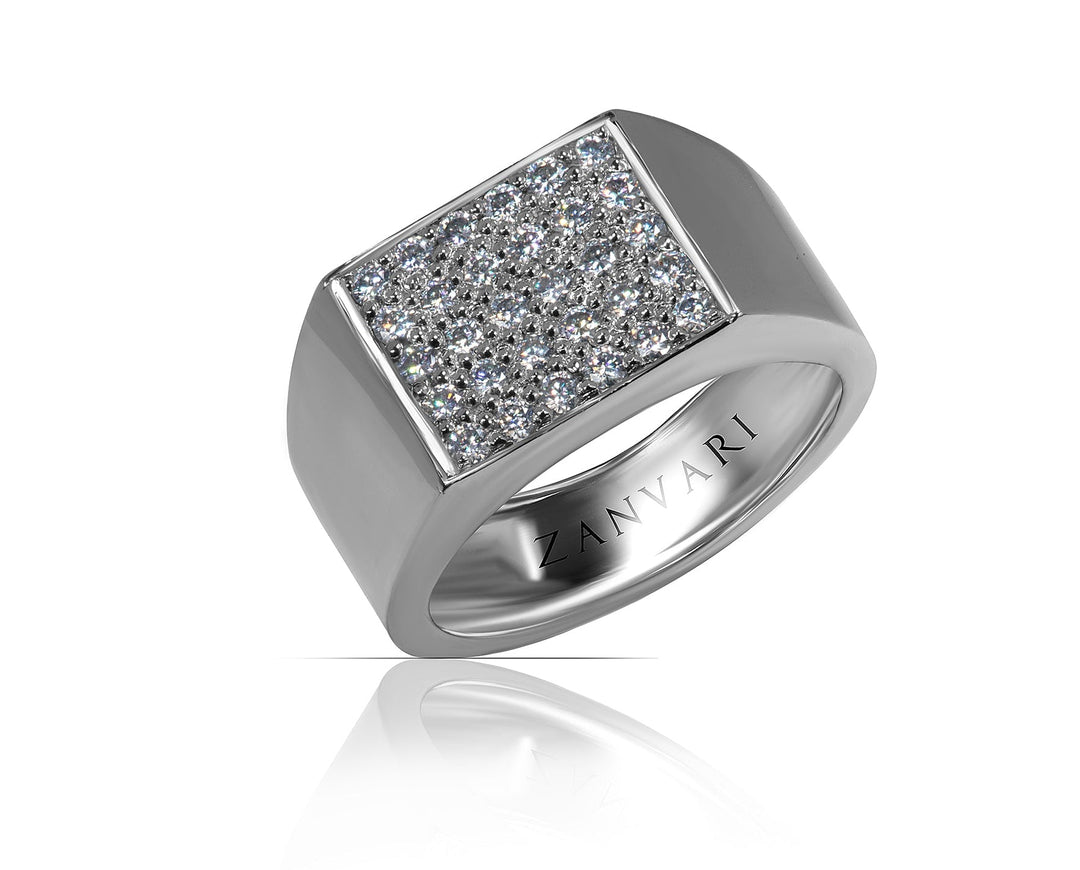 A silver-toned men's signet ring by Zanvari, featuring a square face paved with clear moissanite stones. The brand name 'ZAVARI' is engraved on the inner band.