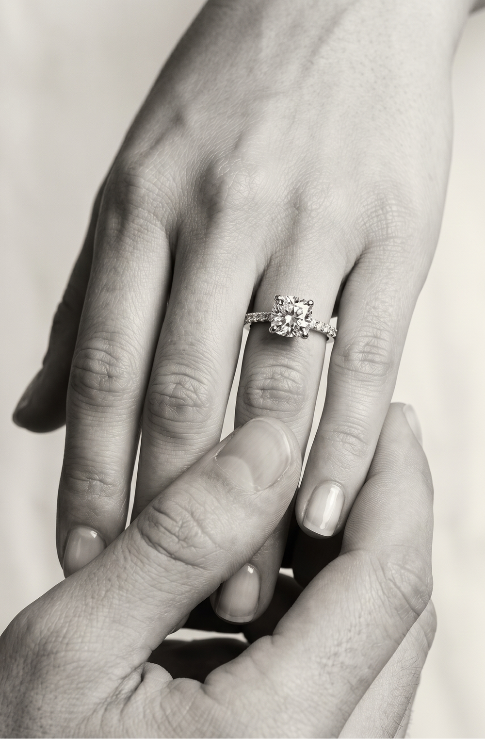 Wmen wearing a proposal ring in cushion cut moissanite