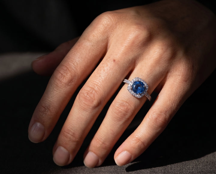 Bold luxury jewelry hand shoot featuring a female model wearing a Zanvari ring, close-up of a naturally manicured hand in dramatic lighting with the ring prominently in focus.