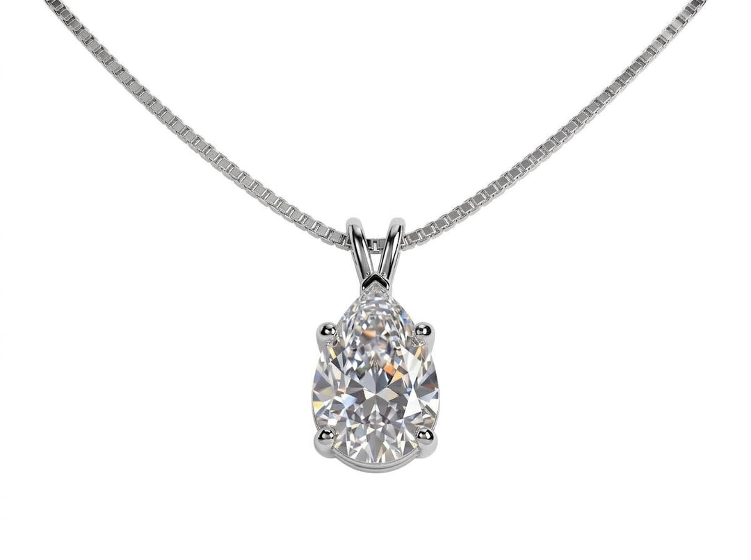A pear-cut diamond pendant necklace in a silver four-prong setting on a silver box chain, isolated on a white background.