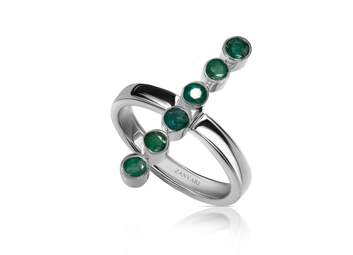 Close-up of emerald bezel-set band showing 3mm round emeralds in polished rhodium-plated silver handcrafted by Zanvari Jewelry.
