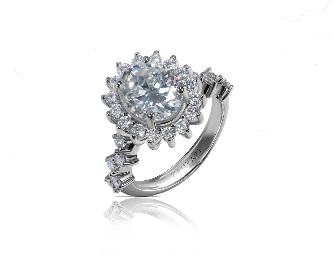 A silver-toned halo ring featuring a oval  brilliant-cut center stone surrounded by multiple round and baguette side stones, shown on a clean white background with a soft reflection below.
