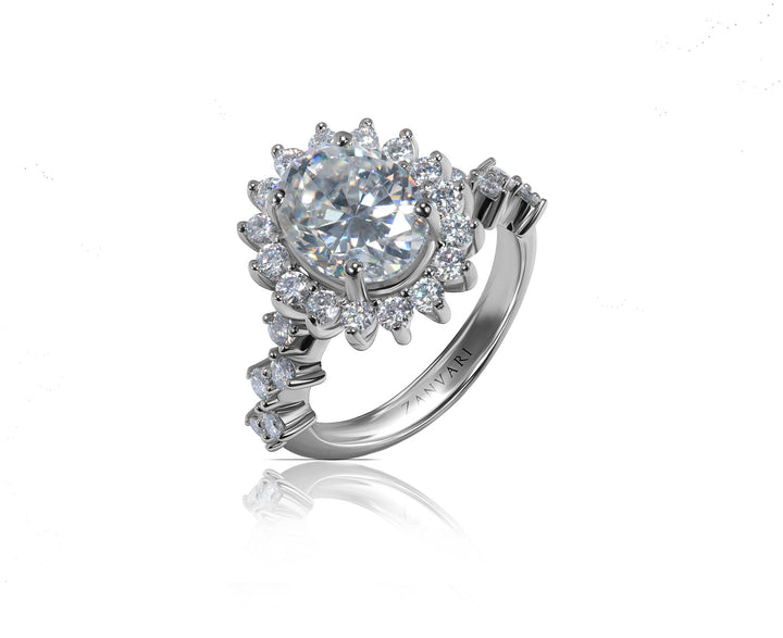 A silver-toned halo ring featuring a oval  brilliant-cut center stone surrounded by multiple round and baguette side stones, shown on a clean white background with a soft reflection below.