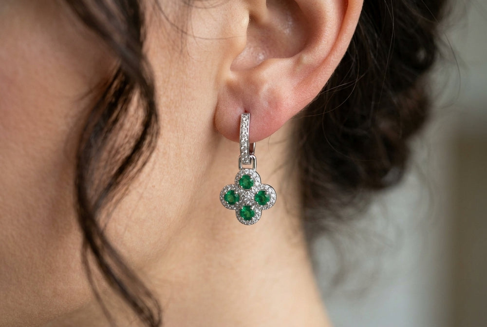 women earlobe wearing emerald green earrings