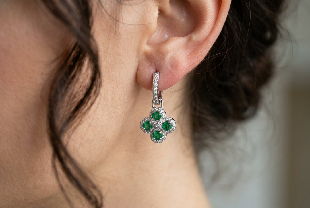 women earlobe wearing emerald green earrings