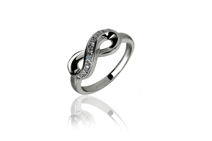 A sterling silver ring with a curved band and a central inset featuring a moissanite gemstone, surrounded by smaller clear stones.