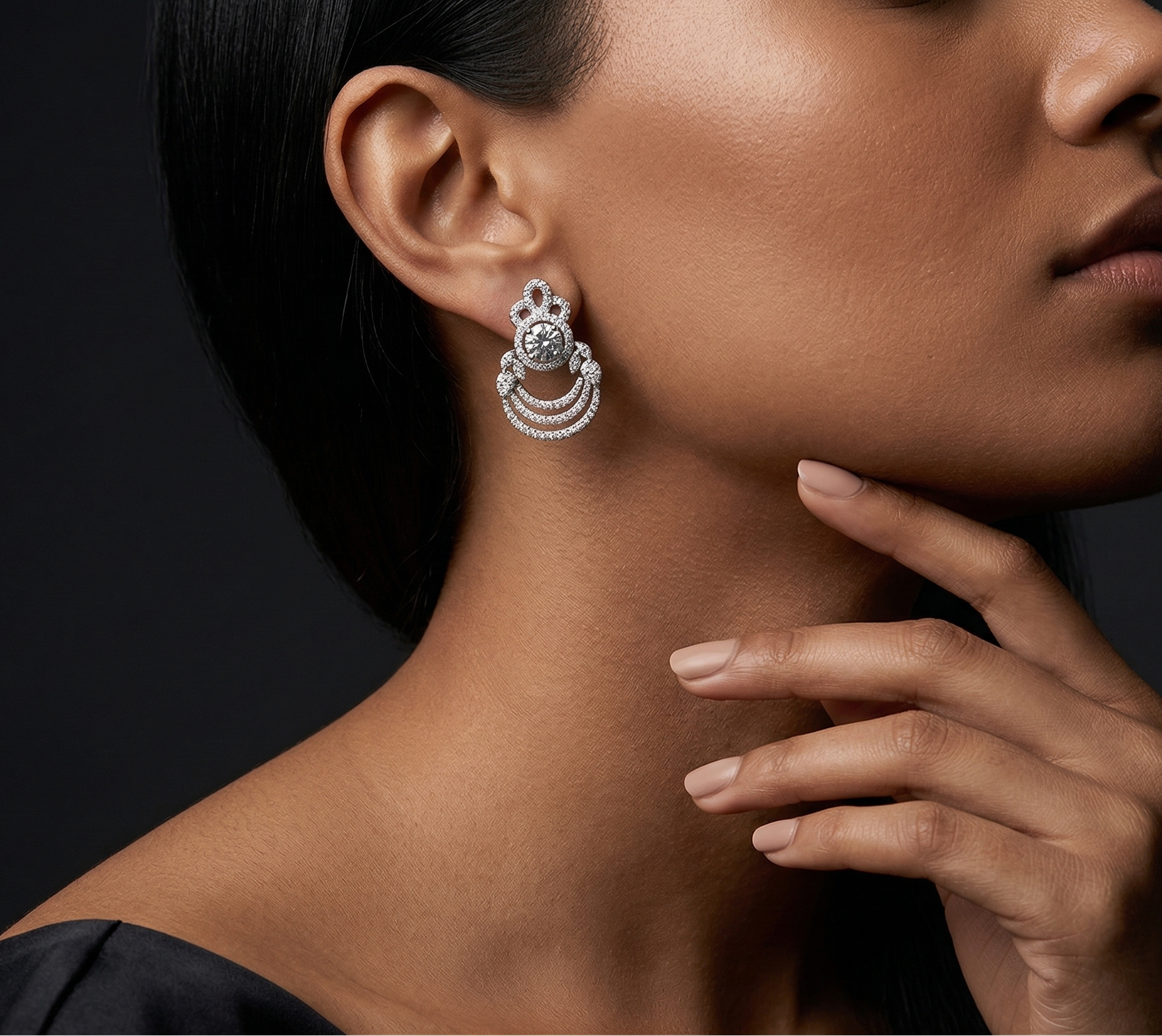 Close-up of a woman wearing a silver earring with a dark background