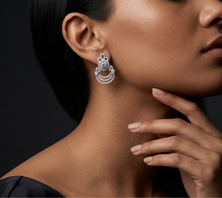 Close-up of a woman wearing a silver earring with a dark background