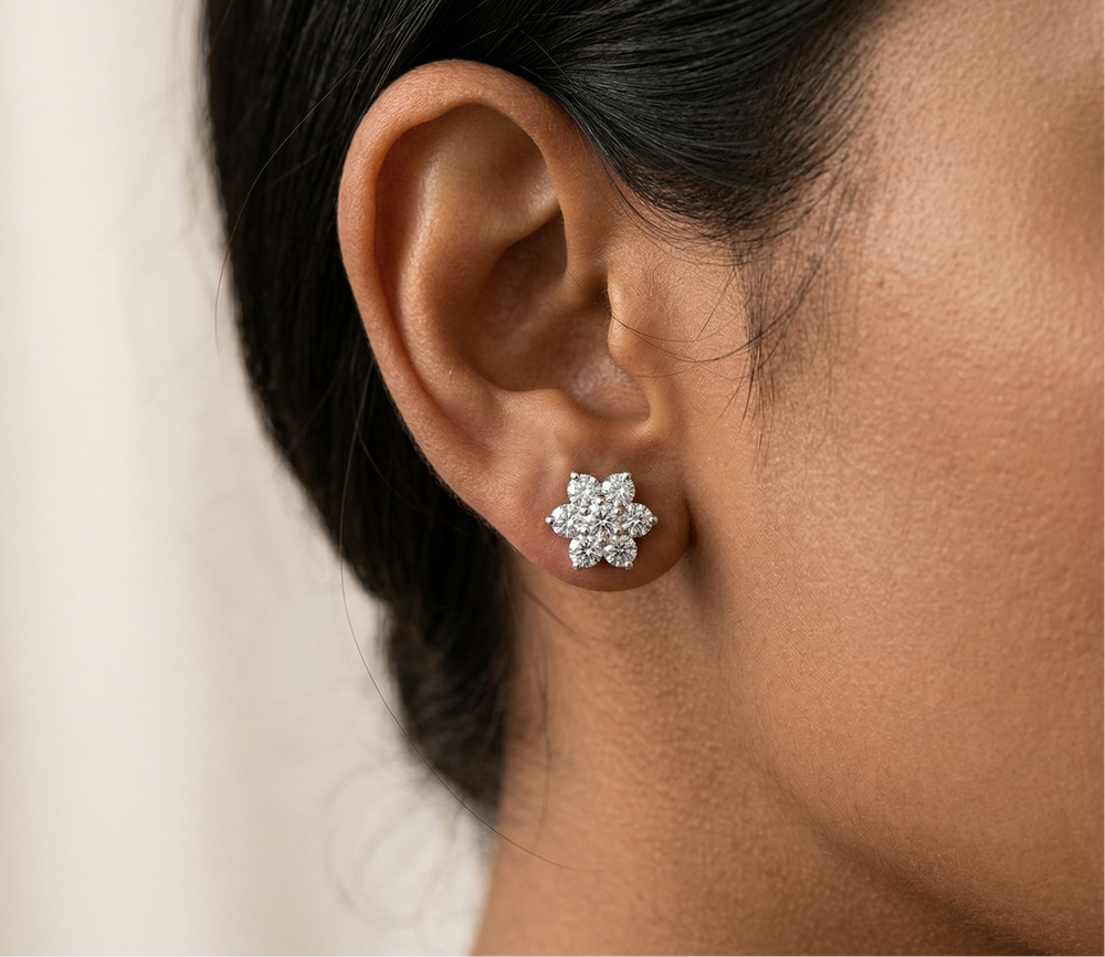 Close-up of an ear wearing a moissanite earring with a blurred background