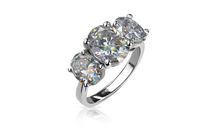 Silver ring with three oval  moissanites on a white background