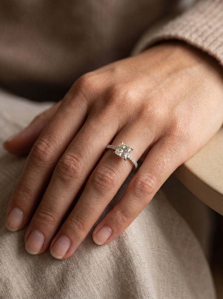 Model wearing zanvari's engagement ring in silver with princess cut moissanite